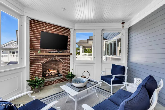 a living room with furniture a flat screen tv and a large window