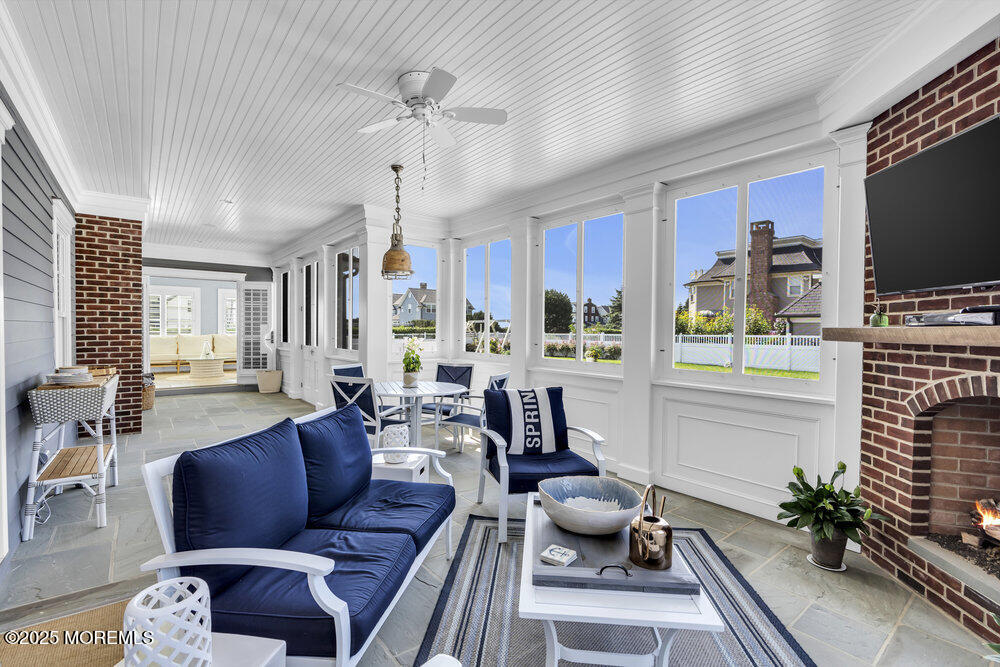 15 Madison Avenue Spring Lake, NJ 07762 - Photo 17 of 53 a living room with furniture a flat screen tv and a large window