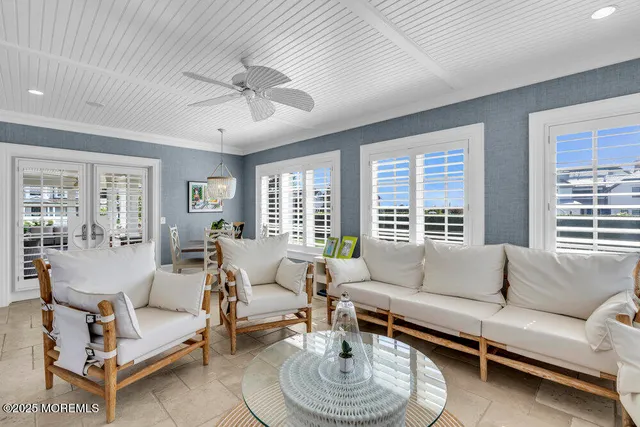 a bedroom with a large bed a flat screen tv and couches