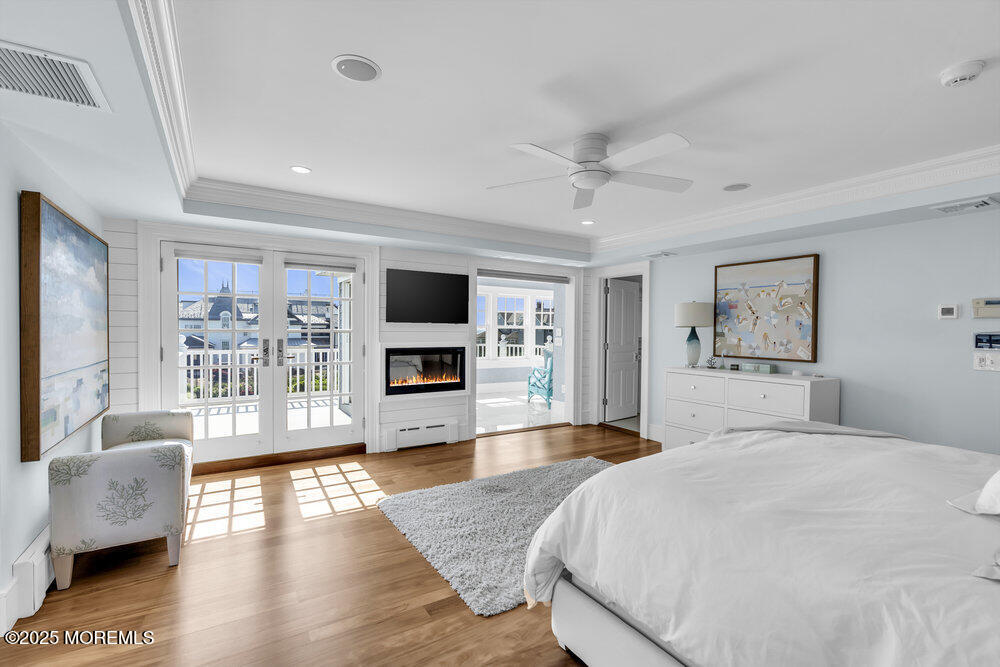 15 Madison Avenue Spring Lake, NJ 07762 - Photo 24 of 53 a bedroom with a large bed a flat screen tv and couches