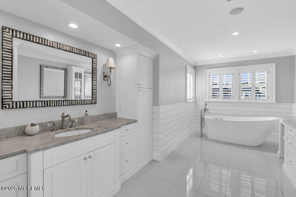 15 Madison Avenue Spring Lake, NJ 07762 - Photo 28 of 53 a spacious bathroom with a double vanity sink a large mirror and a bathtub