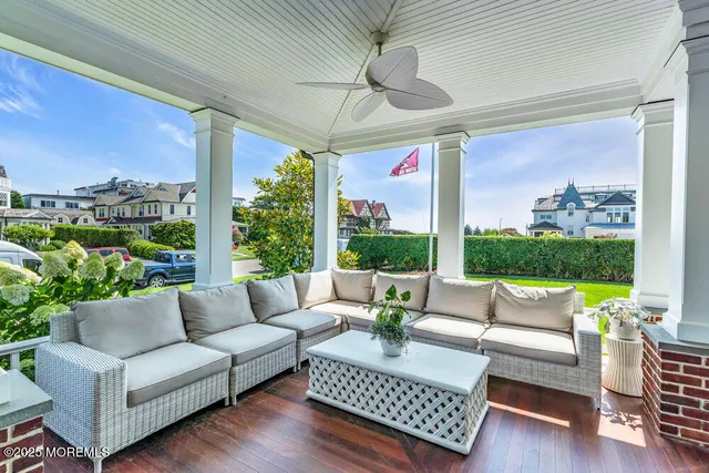 a living room with patio furniture and a floor to ceiling window