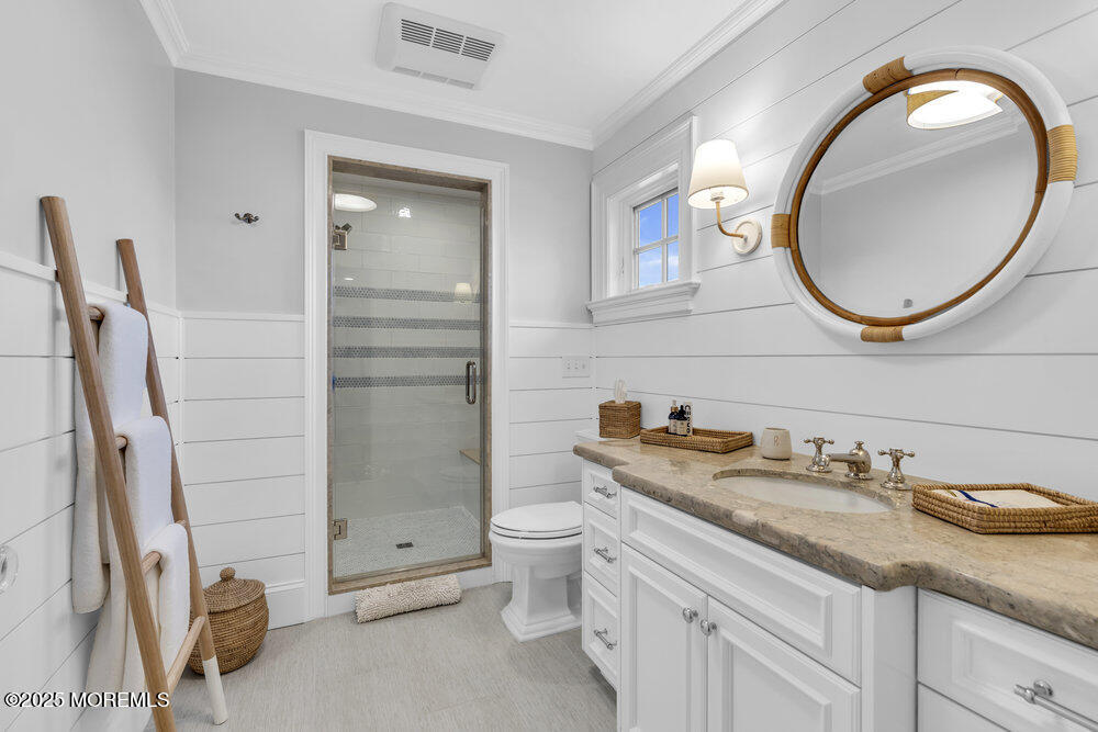 15 Madison Avenue Spring Lake, NJ 07762 - Photo 31 of 53 a bathroom with a granite countertop toilet sink and mirror