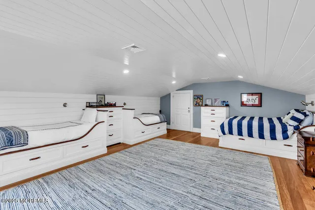 a large room with wooden floor and furniture