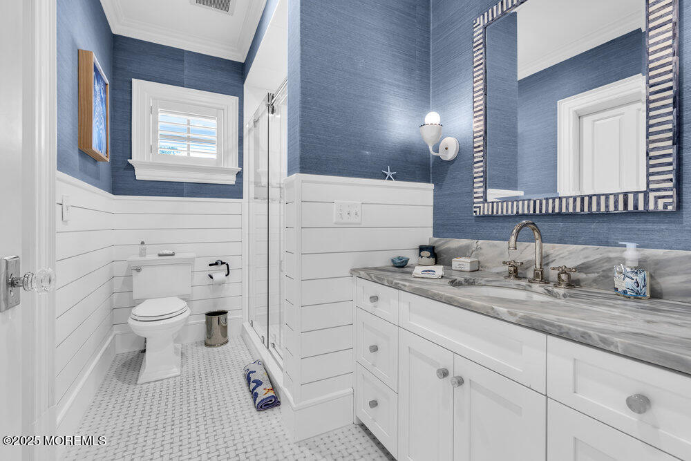 15 Madison Avenue Spring Lake, NJ 07762 - Photo 43 of 53 a bathroom with a granite countertop toilet sink and mirror