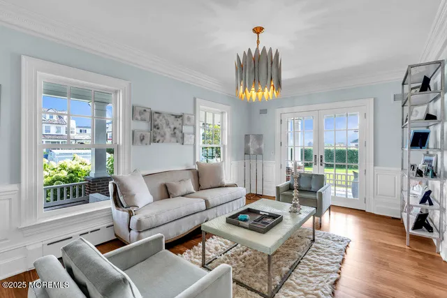 a view of a dining room with furniture wooden floor and a chandelier