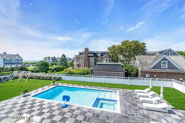 a view of swimming pool with a yard and a big yard