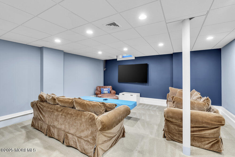 15 Madison Avenue Spring Lake, NJ 07762 - Photo 51 of 53 a living room with furniture and a flat screen tv