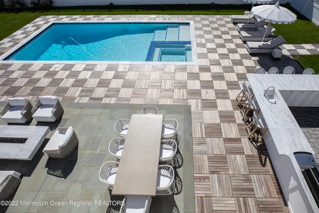 a view of a swimming pool with outdoor seating