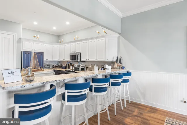 a bedroom with two beds and a painting on the wall