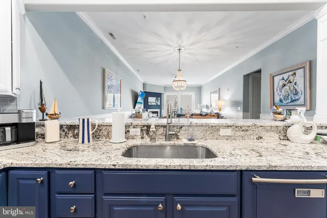 a view of a bedroom with a bed and a table in it