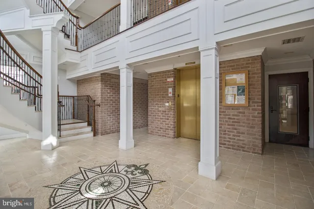 a view of hallway with furniture and wooden floor