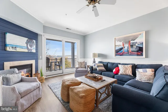 a dining room with furniture a chandelier and wooden floor