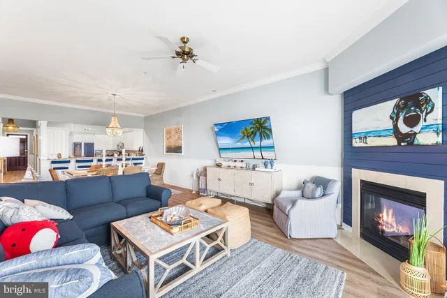 a kitchen with stainless steel appliances granite countertop a stove top oven a sink dishwasher a refrigerator and a cabinets with wooden floor