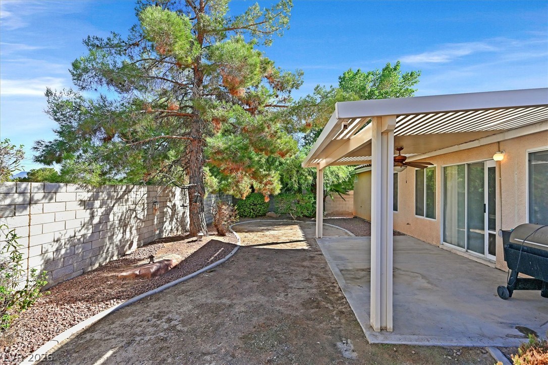 8830 Haviland Road Las Vegas, NV 89123 - Photo 26 of 43 An inviting covered patio provides a shaded outdoor space alongside the enclosed backyard.