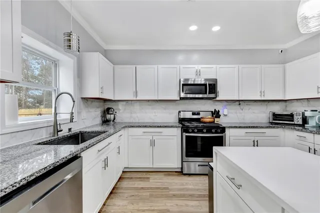 a kitchen with a sink stove and microwave