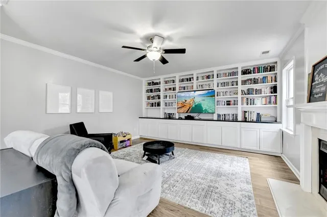 a living room with stainless steel appliances kitchen island granite countertop furniture and a wooden floor