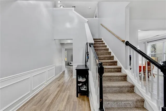 a view of a staircase and wooden floor in a room