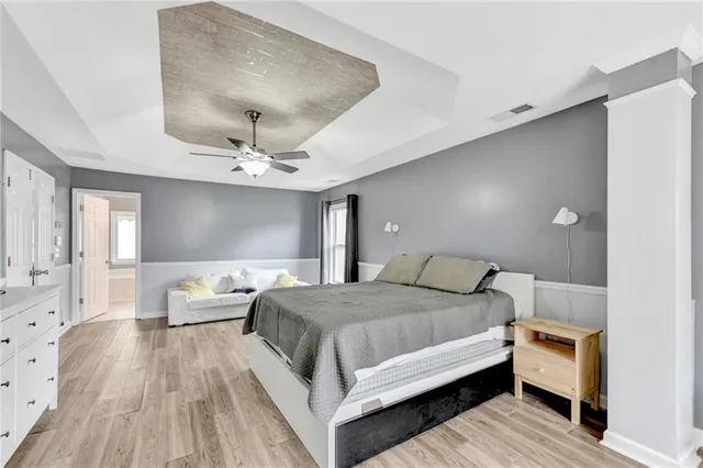 a bedroom with a bed and wooden floor