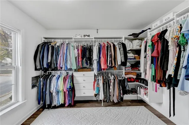 a view of walk in closet with clothes