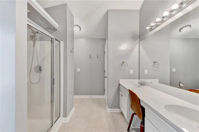 a bathroom with a double vanity sink mirror and shower