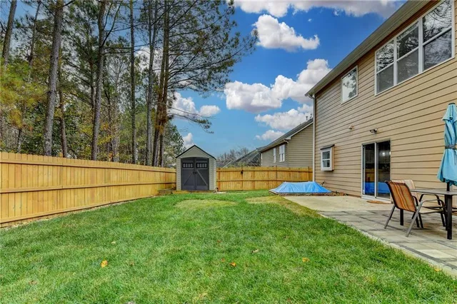 a view of a house with a yard and sitting area