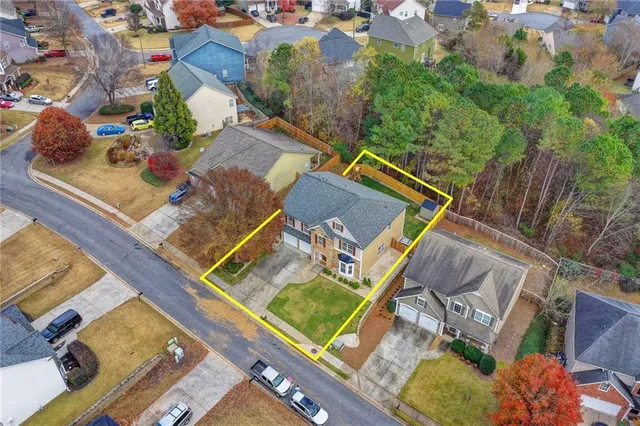 an aerial view of residential houses with outdoor space