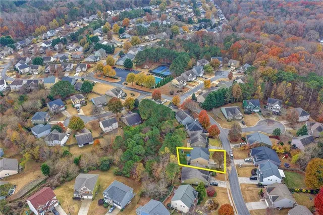 an aerial view of a house with a yard