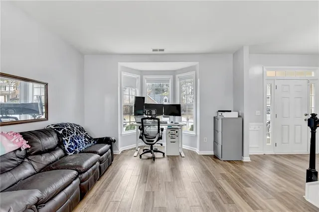 a living room with furniture and a wooden floor