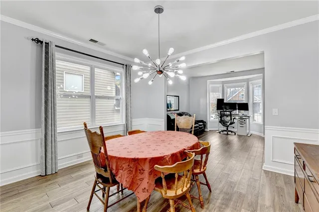 a view of a dining room with furniture and wooden floor