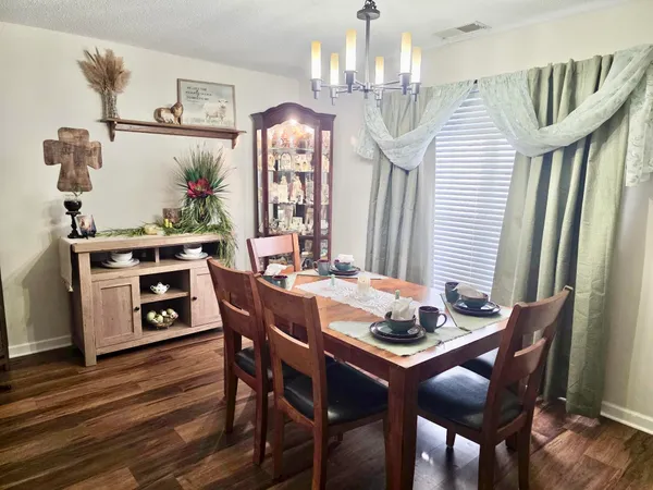 a dining room with furniture and wooden floor