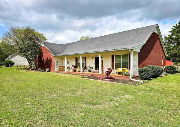 a view of a house with backyard porch and sitting area