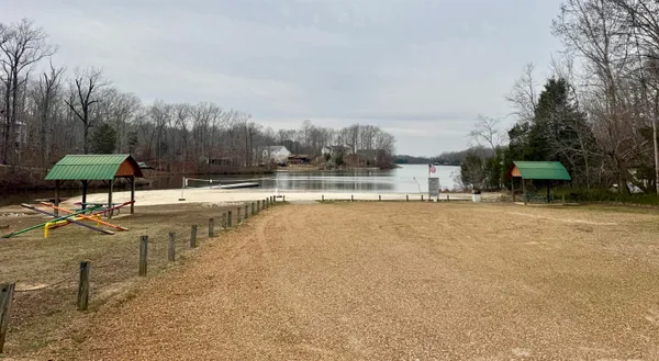 a view of a lake with a yard and sitting area