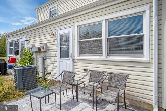 a view of a chair and table in the balcony