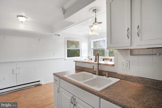 a kitchen with a sink cabinets and window