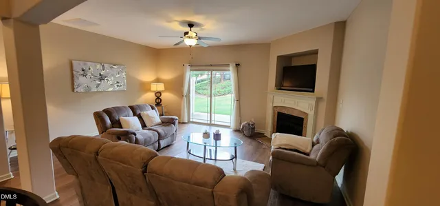 a living room with furniture a fireplace and a flat screen tv