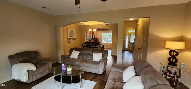 a living room with furniture and a mirror