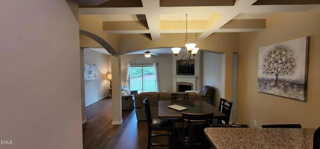 a view of a workspace with furniture and a chandelier