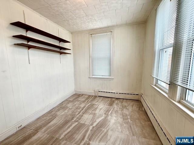 405 7th Street Harrison, NJ 07029 - Photo 13 of 21 a view of a room with rack on the wall and a window