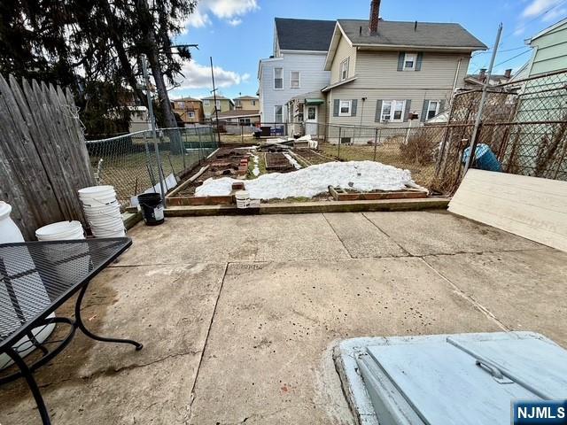 405 7th Street Harrison, NJ 07029 - Photo 20 of 21 a view of a patio with table and chairs with wooden floor and fence