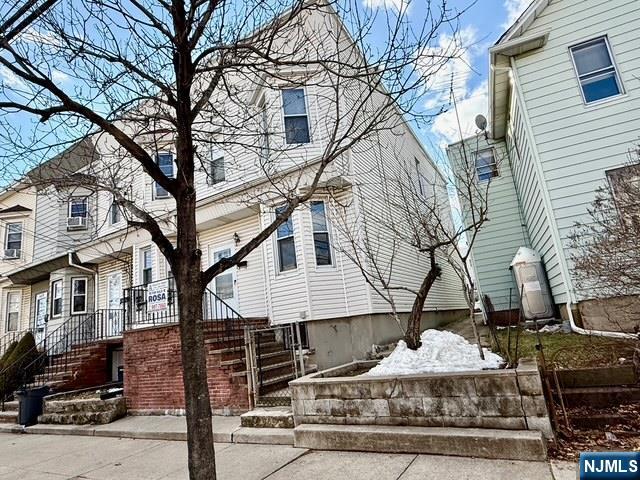 405 7th Street Harrison, NJ 07029 - Photo 2 of 21 a front view of a house with garage and trees