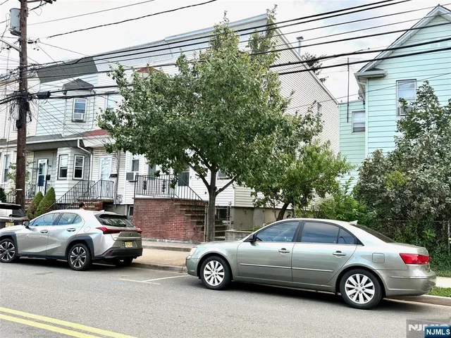 a view of a car parked in front of a house
