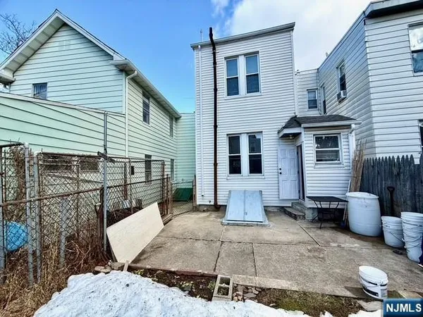 a view of a house with a patio and a yard