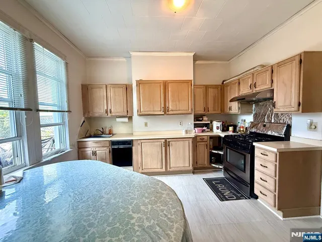 a kitchen with stainless steel appliances granite countertop a stove cabinets sink and a granite counter top
