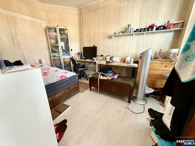 a bed room with a bed and a chair