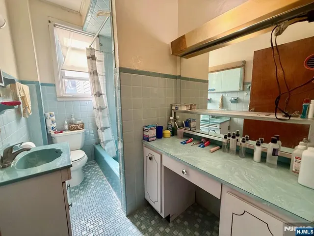 a kitchen with sink a stove and cabinets