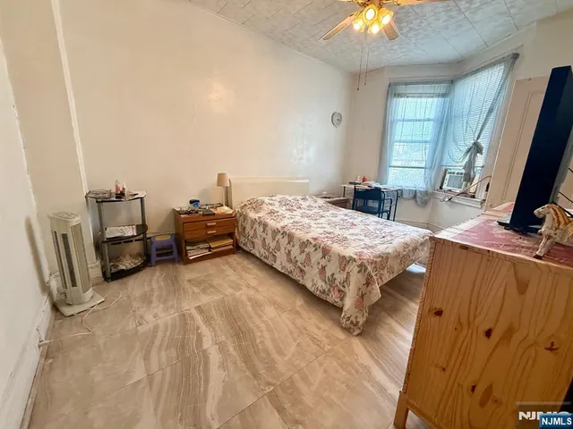a spacious bedroom with a bed and a chandelier