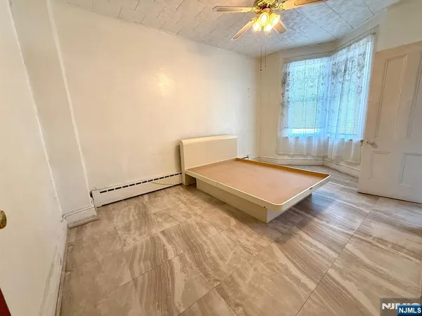 a living room with a bed and a chandelier