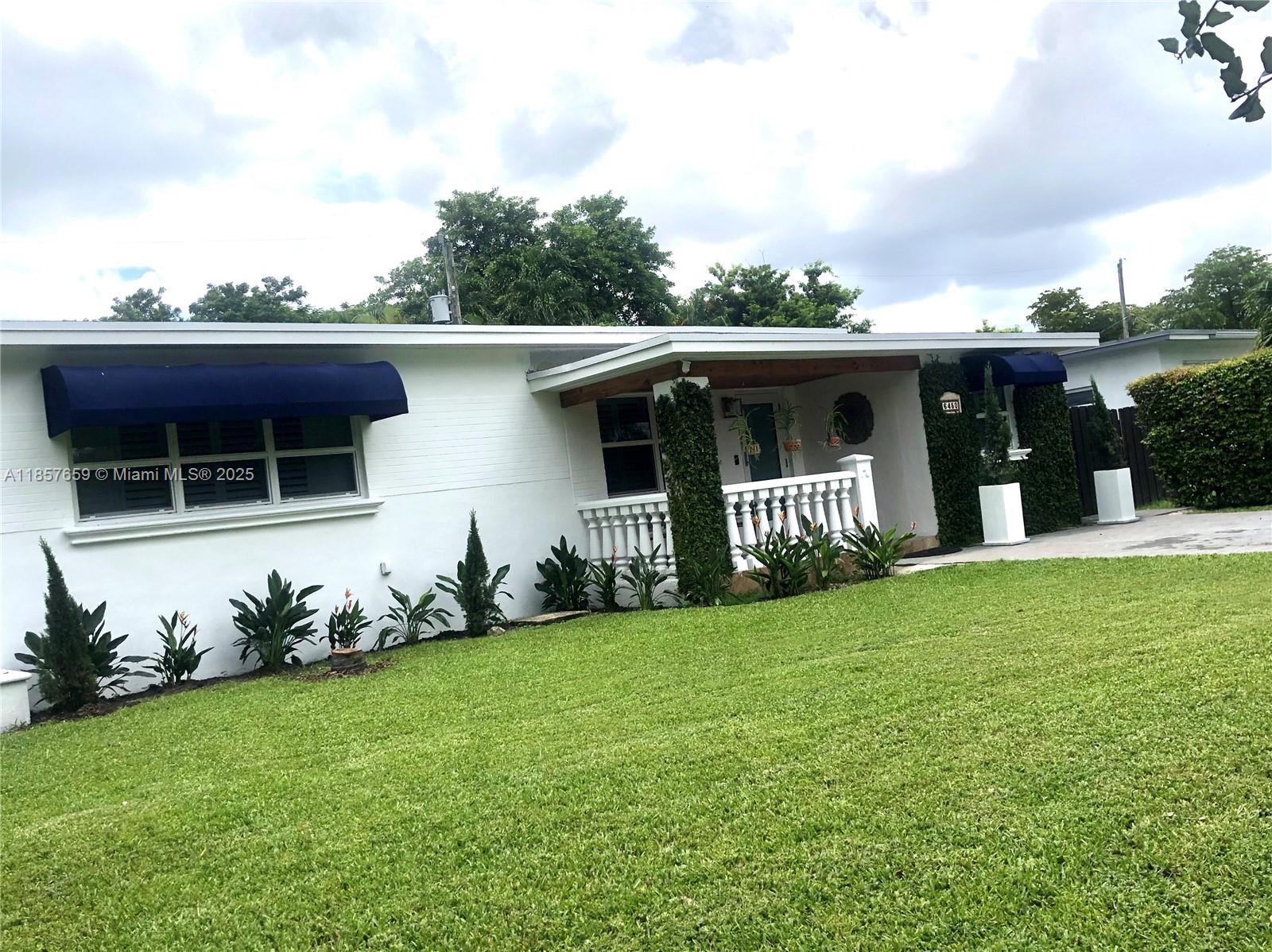 6450 Southwest 19th Street West Miami, FL 33155 - Photo 1 of 42 a front view of a house with garden