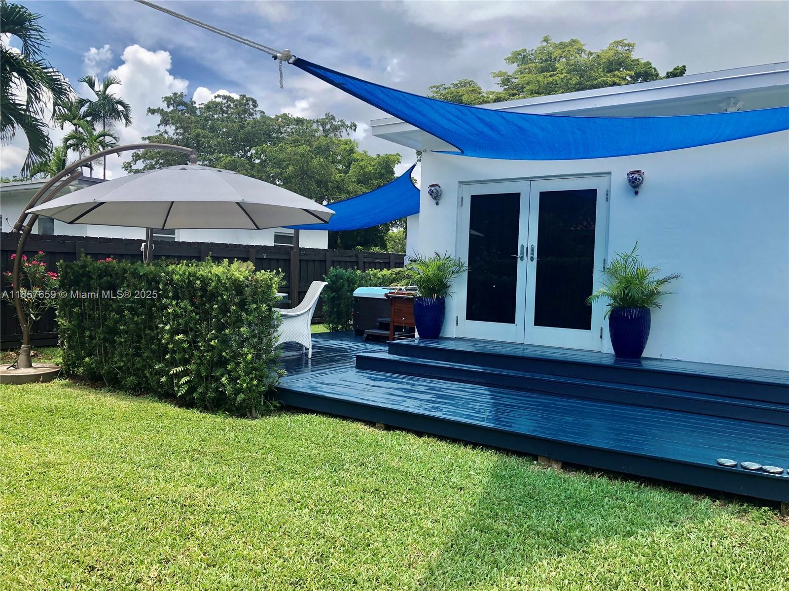 6450 Southwest 19th Street West Miami, FL 33155 - Photo 11 of 42 a front view of a house with garden